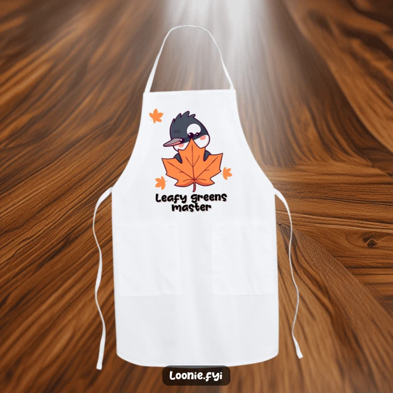 Funny apron with a curious loon peeking from behind a maple leaf, adding a touch of humor to kitchen tasks.