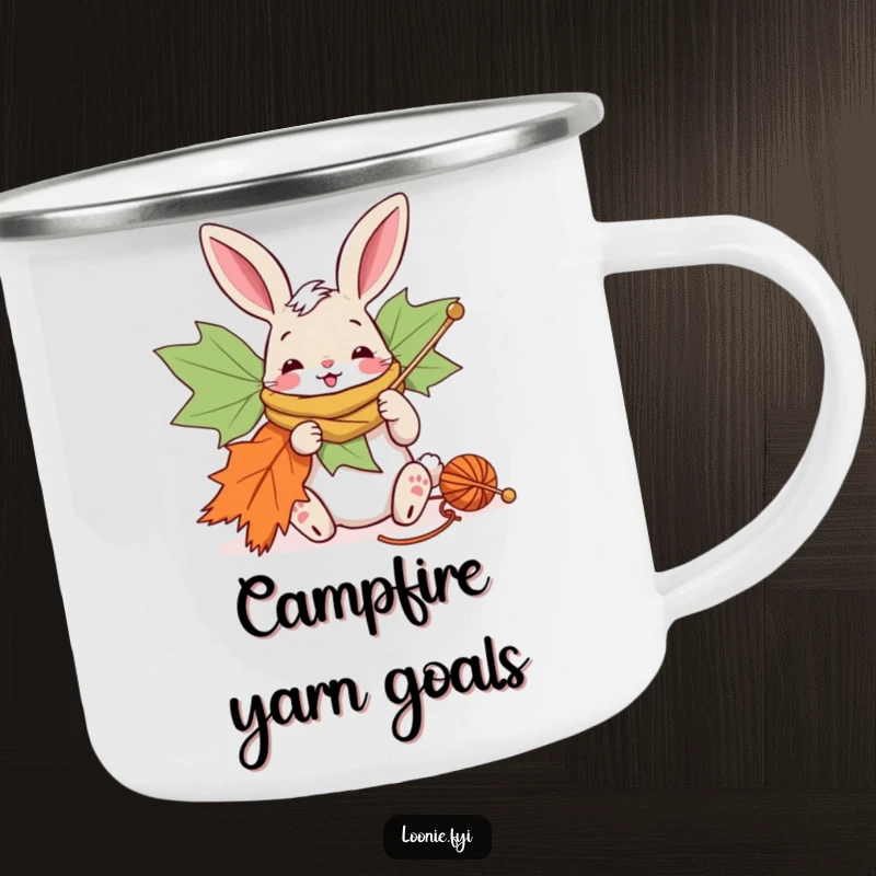 Funny camping mug with a bunny knitting a giant maple leaf scarf, great for outdoor craft lovers.