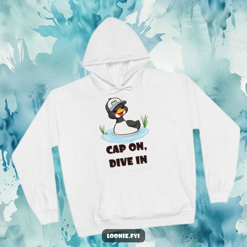 Funny hoodie featuring a playful loon wearing a baseball cap, captured in the exciting moment of diving into a small lake.