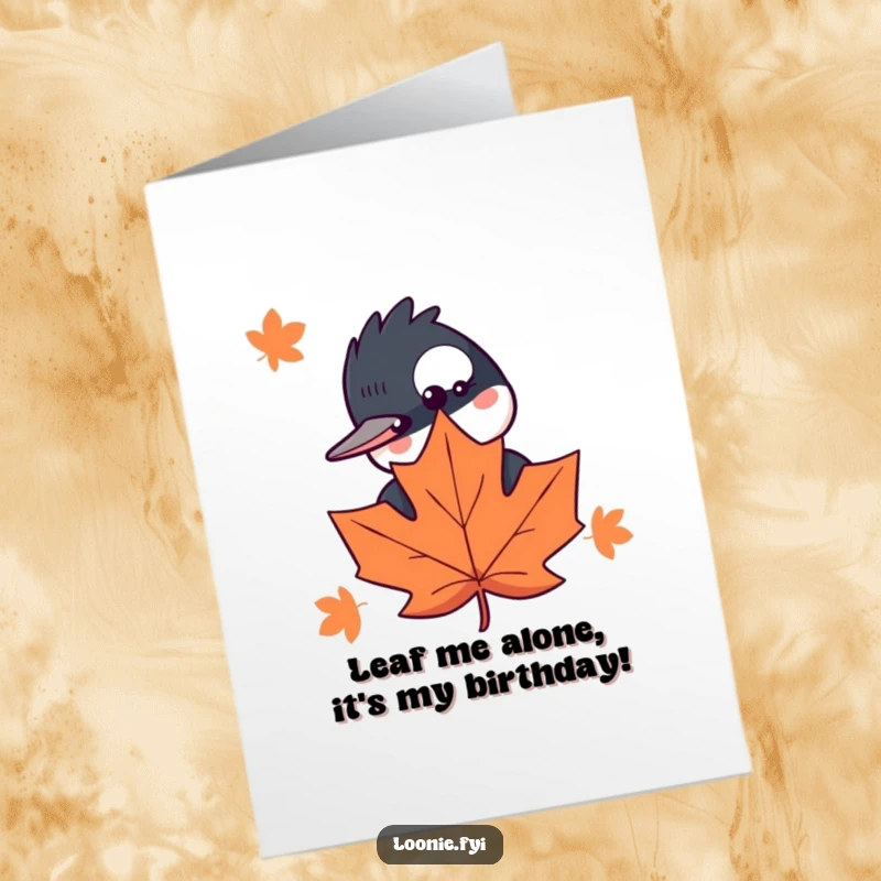 Funny Free Printable Birthday Card: A curious loon with wide eyes peeks slyly from behind a large maple leaf.